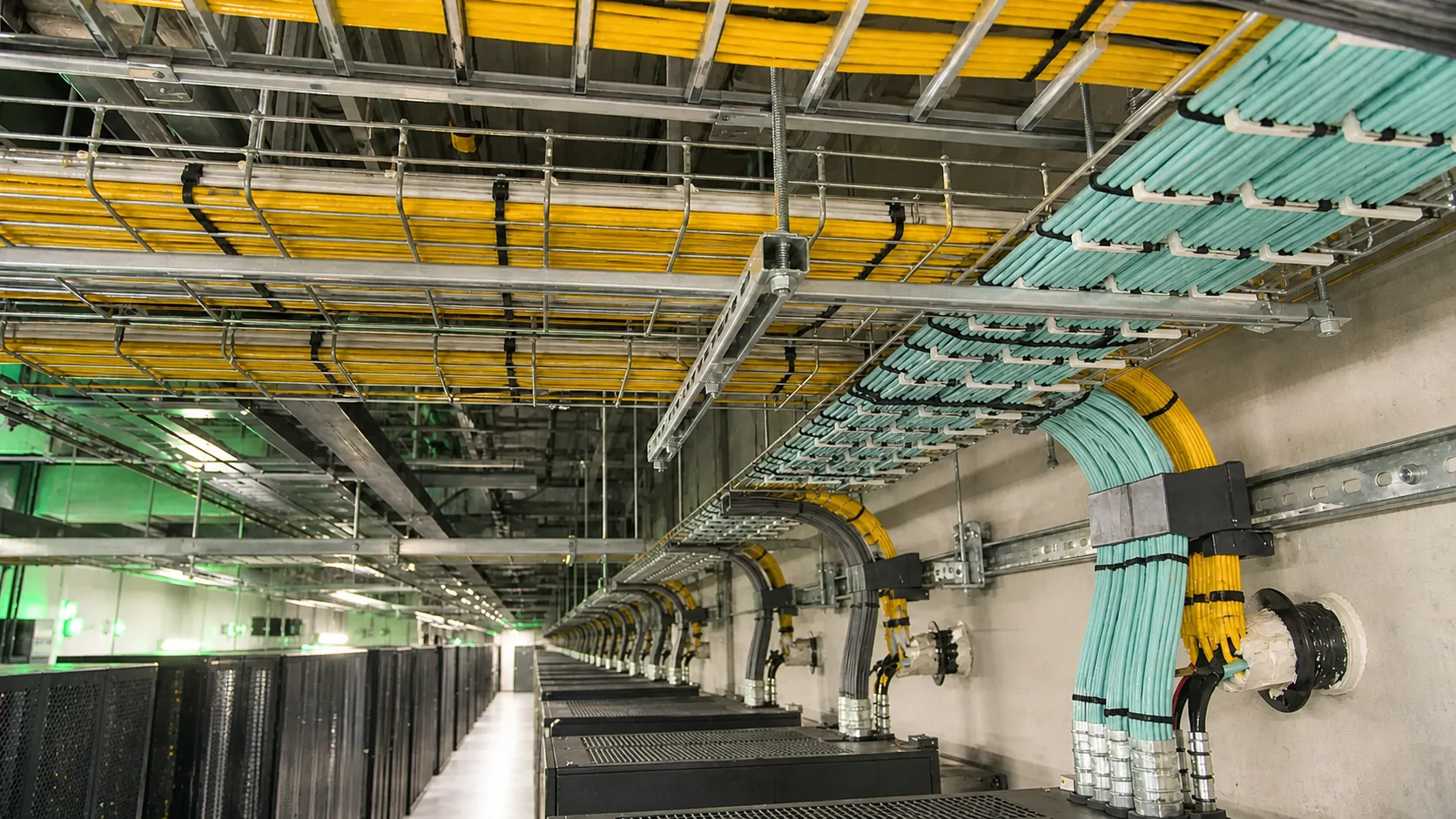 Overhead trays carrying color-coded fiber and network cabling